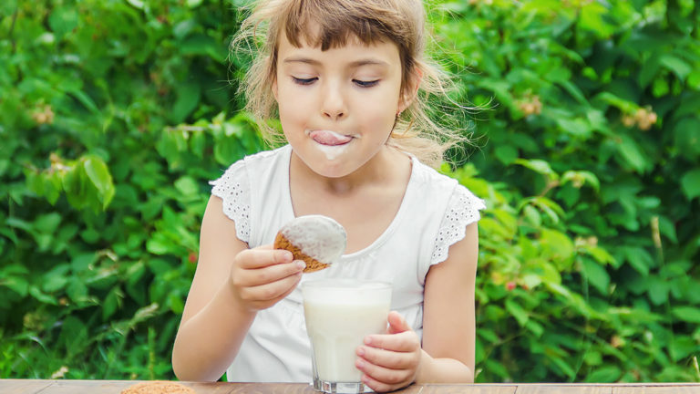 food nostalgia: girl dipping cookies in milk