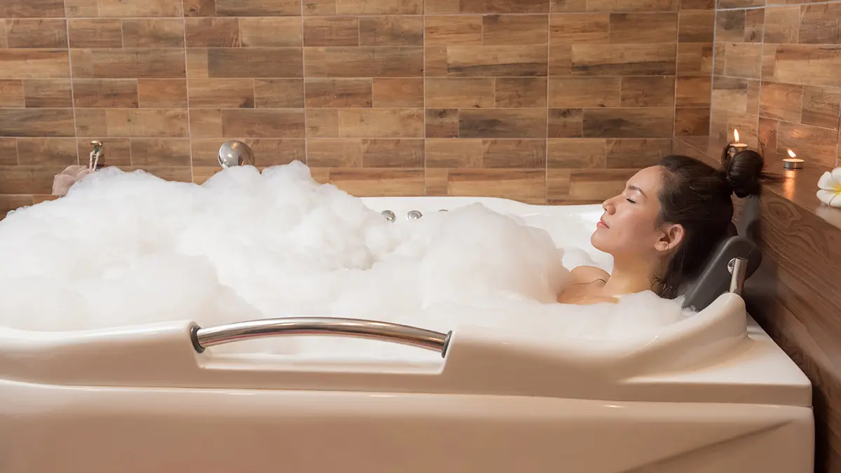 spring equinox activities: woman taking a relaxing bath