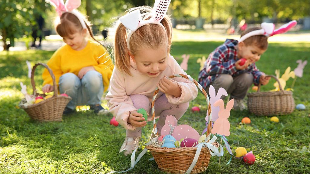 photo of easter egg hunt ideas: kids hunting for easter eggs