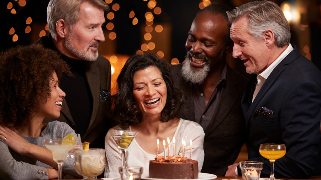 a photo of 50th birthday gift ideas: friends celebrating woman's birthday