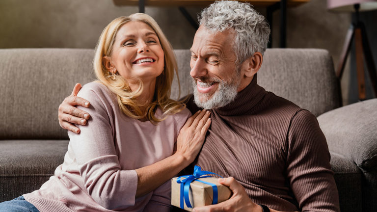 a photo of 50th birthday gift ideas: husband giving wife birthday present