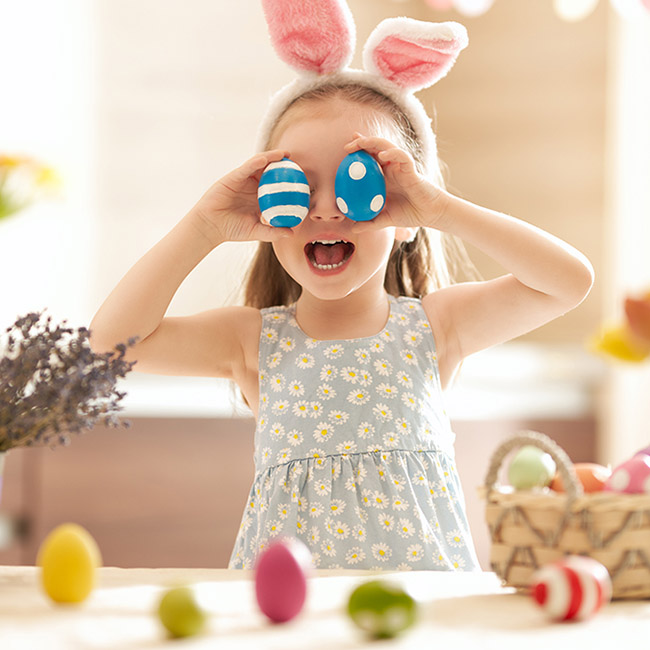 easter egg hunt with girl playing with easter eggs