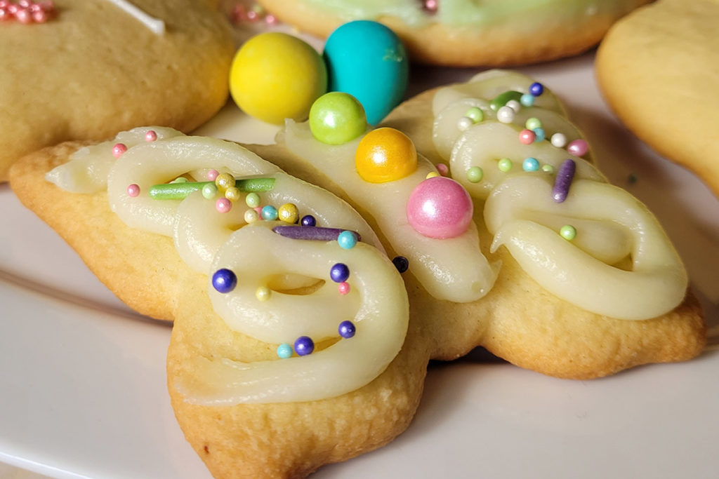 a photo of Easter cookie decorating: decorated butterfly cookie for Easter