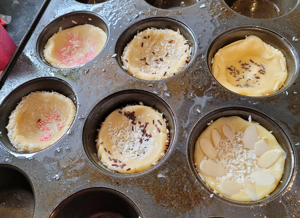 a photo of Easter cookie decorating: nests in muffin tin