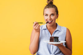 a photo of a woman eating devil's food cake