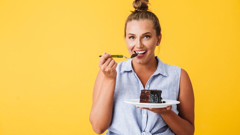 a photo of a woman eating devil's food cake