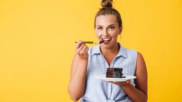 a photo of a woman eating devil's food cake