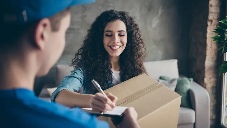 a photo of finals week care packages: student receiving a care package