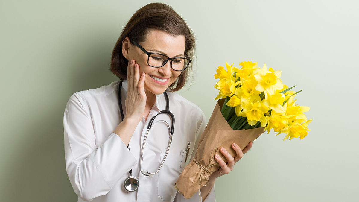 a photo of nurses week: nurse receiving flowers