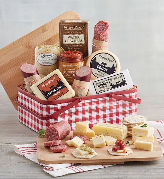 A photo of picnic with a meat and cheese tin
