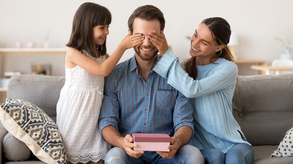 A photo of father's day messages with wife and daughter giving dad father's day gift