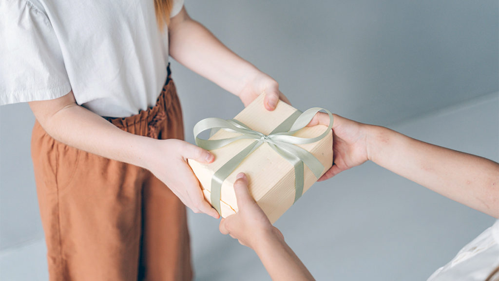 a photo of psychology of gifting with person receiving a gift box