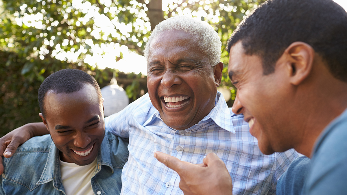 A photo of dad jokes with a dad telling his sons a joke