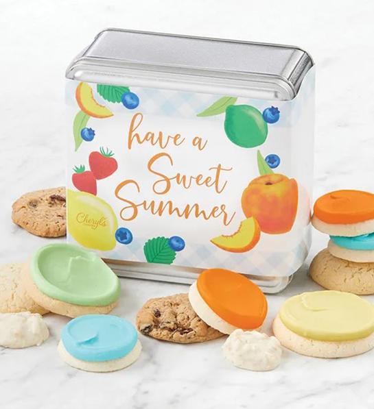A photo of a picnic tin of cookies that says "have a great summer" across the lid with cookies surrounding the box