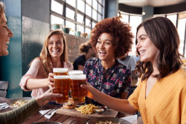 photo of alt bash with four young female friends meeting for drinks and food at a restaurant