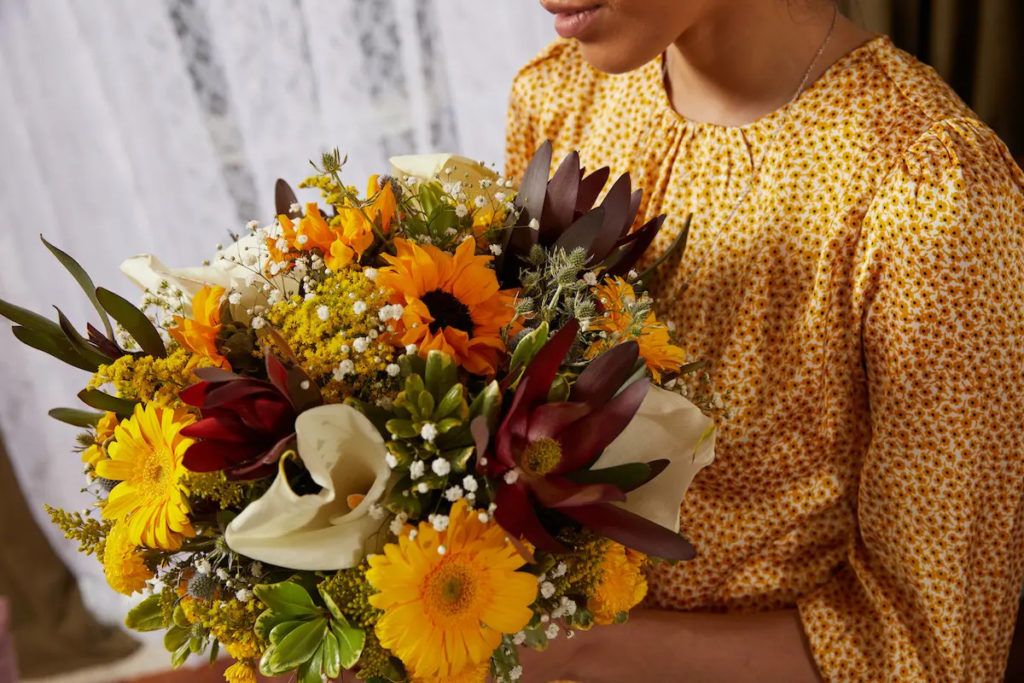 photo of milestone birthdays with girl holding flowers for 18th birthday