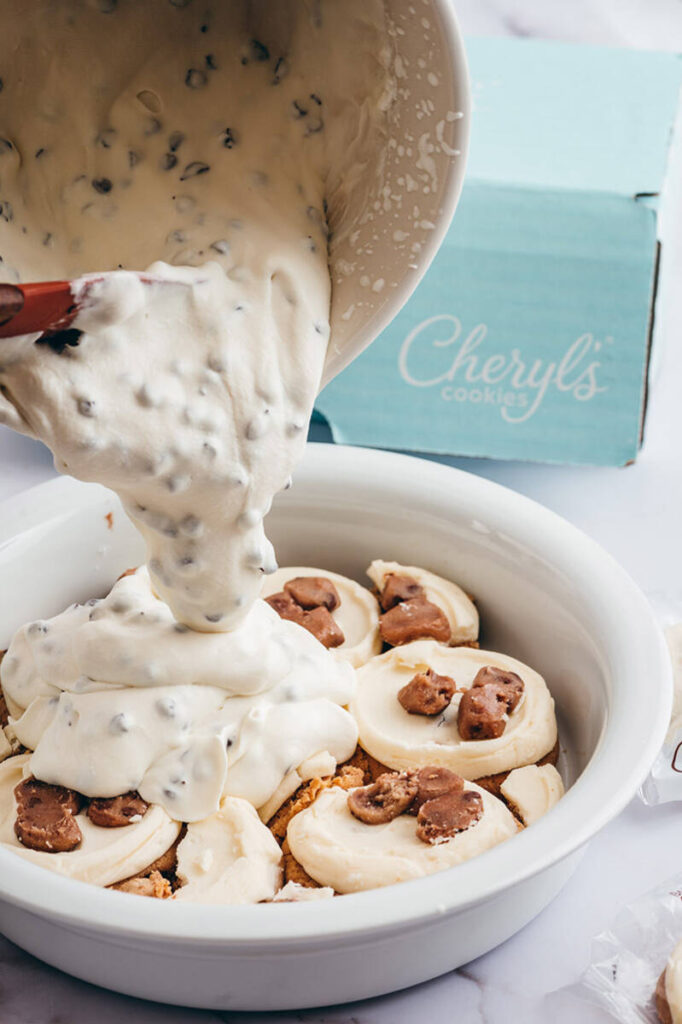 ice cream pie with pouring mixture over cookies