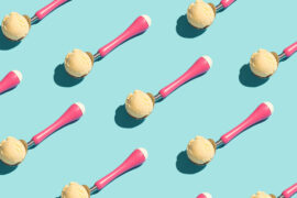 history of ice cream with vanilla Ice cream scoops in pink spoons in food pattern.