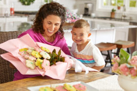motherhood quotes mom and son holding a bouquet of cookie flowers